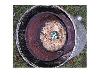 Outer shell, inner shell, burner, pine chips, paper stuffed in hole frame.